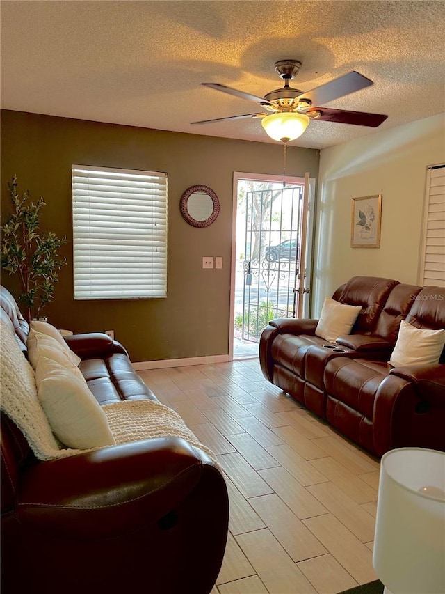 13 W Marbrisa Way, Kissimmee, FL 34743 - living area featuring a textured ceiling, ceiling fan, and baseboards