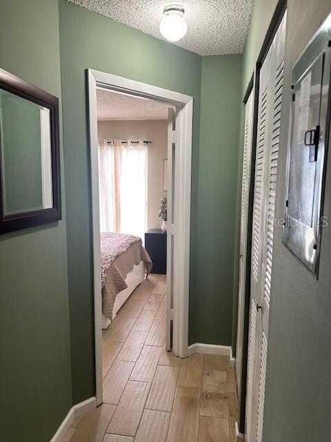 13 W Marbrisa Way, Kissimmee, FL 34743 - hallway with a textured ceiling and baseboards