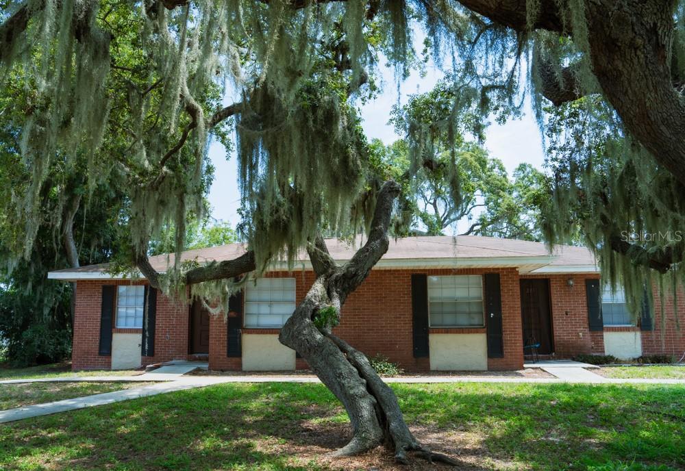 225 Century Blvd Unit A, Auburndale, FL 33823 - single story home featuring brick siding and a front yard