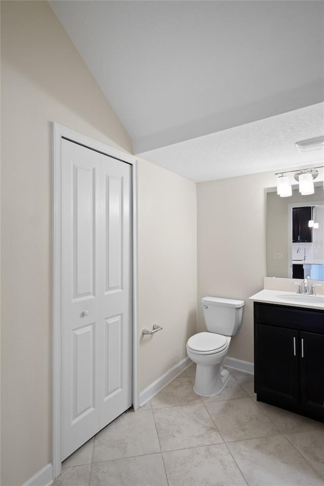 1312 Royal St George Blvd, Davenport, FL 33896 - bathroom featuring toilet, vanity, baseboards, and vaulted ceiling