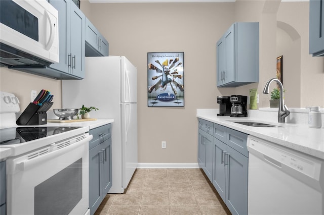 2307 Silver Palm Dr Unit 304, Kissimmee, FL 34747 - kitchen with white appliances, a sink, arched walkways, and blue cabinets