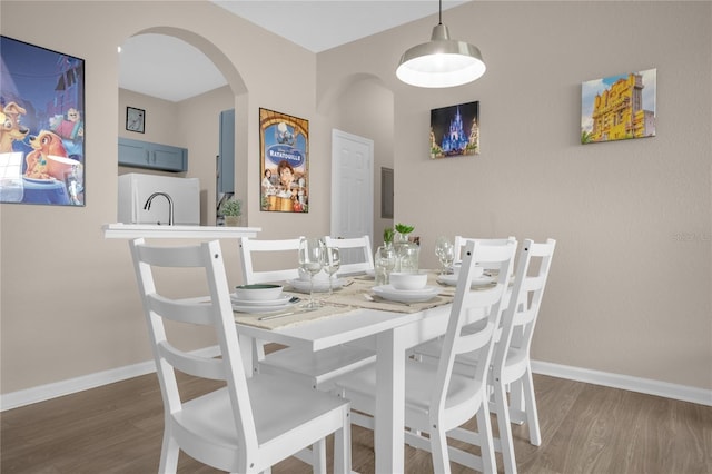 2307 Silver Palm Dr Unit 304, Kissimmee, FL 34747 - dining room with wood finished floors, baseboards, and arched walkways