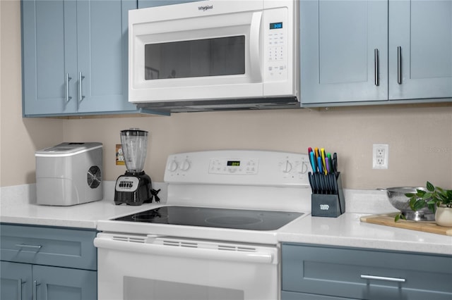 2307 Silver Palm Dr Unit 304, Kissimmee, FL 34747 - kitchen featuring white appliances, blue cabinets, and light countertops