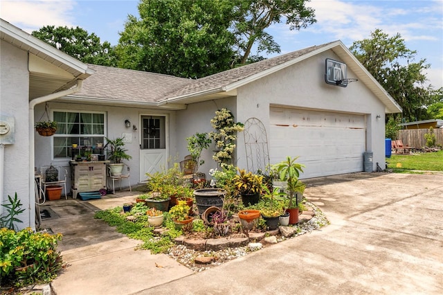 1640 Marks St, Kissimmee, FL 34746 - view of front of property with stucco siding, roof with shingles, driveway, and an attached garage