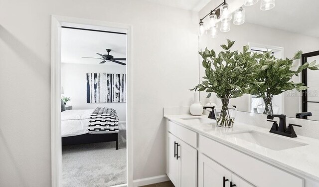 762 Lake Dell Ave, Dundee, FL 33838 - ensuite bathroom with double vanity, ceiling fan, and baseboards