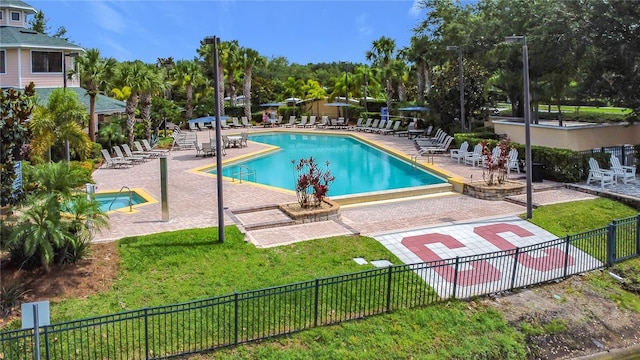 9055 Treasure Trove Ln Unit 207, Kissimmee, FL 34747 - community pool featuring a patio and view of scattered trees