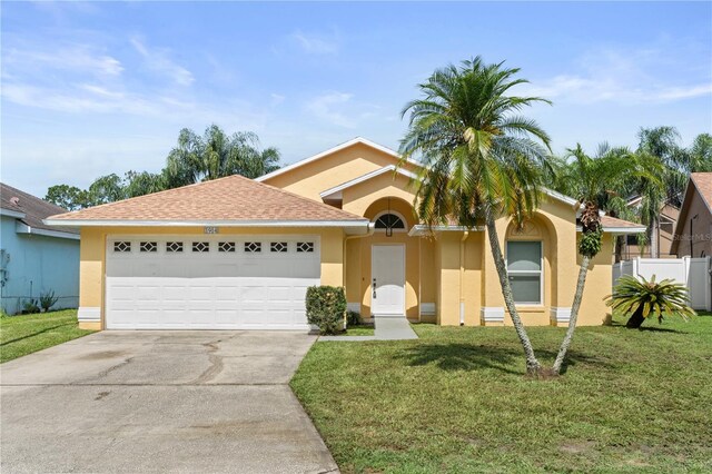 1914 Ellery Ln, Kissimmee, FL 34746 - view of front facade with concrete driveway, stucco siding, and an attached garage