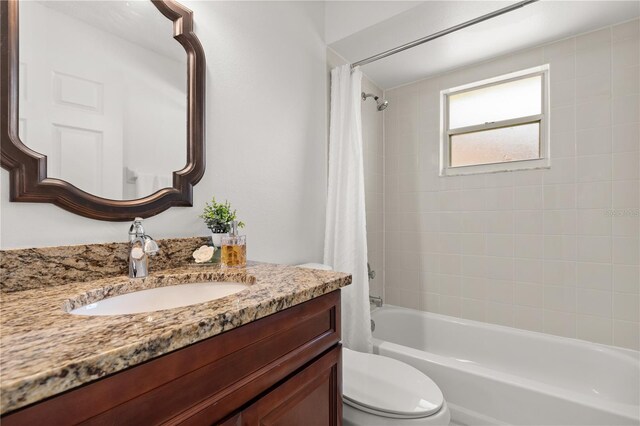 1914 Ellery Ln, Kissimmee, FL 34746 - bathroom featuring toilet, vanity, and shower / tub combo with curtain