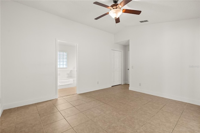 1914 Ellery Ln, Kissimmee, FL 34746 - spare room with ceiling fan, light tile patterned floors, vaulted ceiling, and baseboards