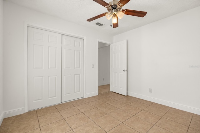 1914 Ellery Ln, Kissimmee, FL 34746 - unfurnished bedroom featuring a closet, light tile patterned floors, baseboards, and ceiling fan