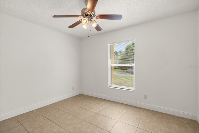 1914 Ellery Ln, Kissimmee, FL 34746 - spare room with light tile patterned floors, a textured ceiling, baseboards, and ceiling fan