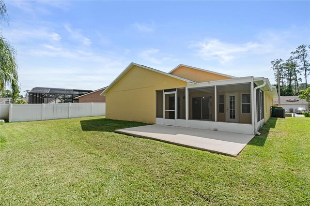 1914 Ellery Ln, Kissimmee, FL 34746 - rear view of house with a sunroom, cooling unit, and stucco siding