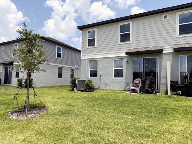 2086 Crape Jasmine Ln, Orlando, FL 32824 - back of property with a yard, stucco siding, and central air condition unit