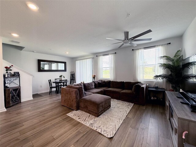 2086 Crape Jasmine Ln, Orlando, FL 32824 - living room featuring wood finished floors, ceiling fan, recessed lighting, a textured ceiling, and baseboards