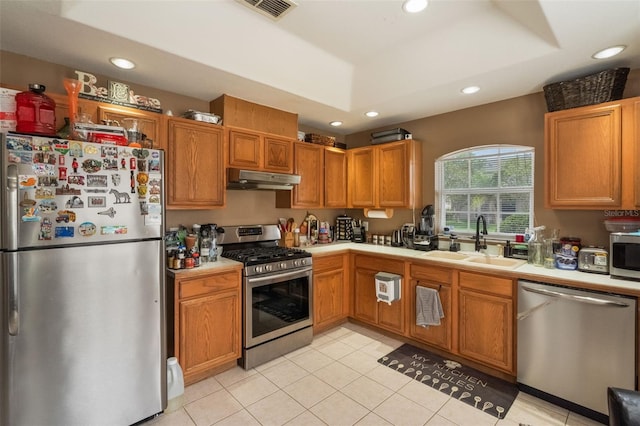 2912 Lazlo Ln, Orlando, FL 32837 - kitchen featuring appliances with stainless steel finishes, under cabinet range hood, a sink, recessed lighting, and light tile patterned floors