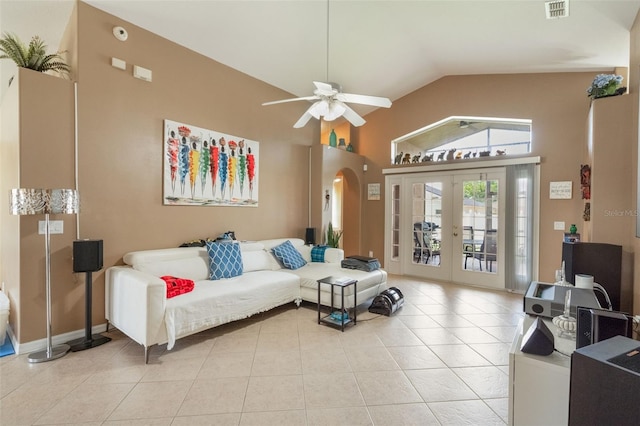 2912 Lazlo Ln, Orlando, FL 32837 - living room with light tile patterned floors, a ceiling fan, french doors, arched walkways, and high vaulted ceiling