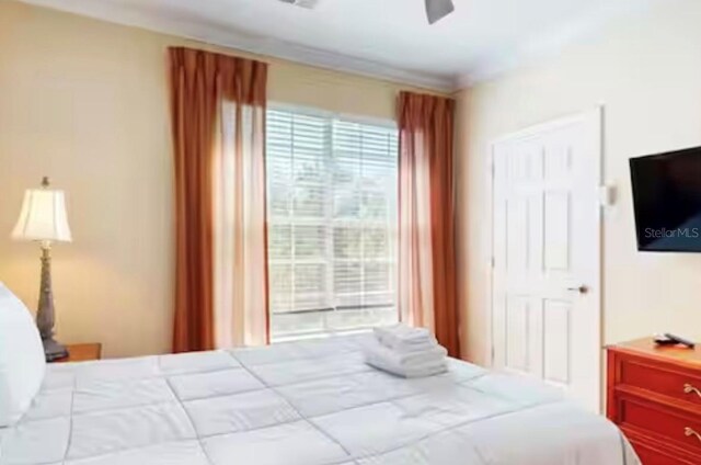 1375 Tuscana Ln Unit 1405, Davenport, FL 33896 - bedroom with crown molding and ceiling fan