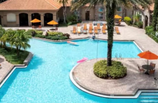 1375 Tuscana Ln Unit 1405, Davenport, FL 33896 - community pool with a patio