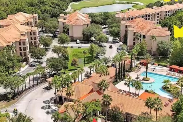 1375 Tuscana Ln Unit 1405, Davenport, FL 33896 - drone / aerial view of a local golf course, a pool, a large body of water, and apartment complex