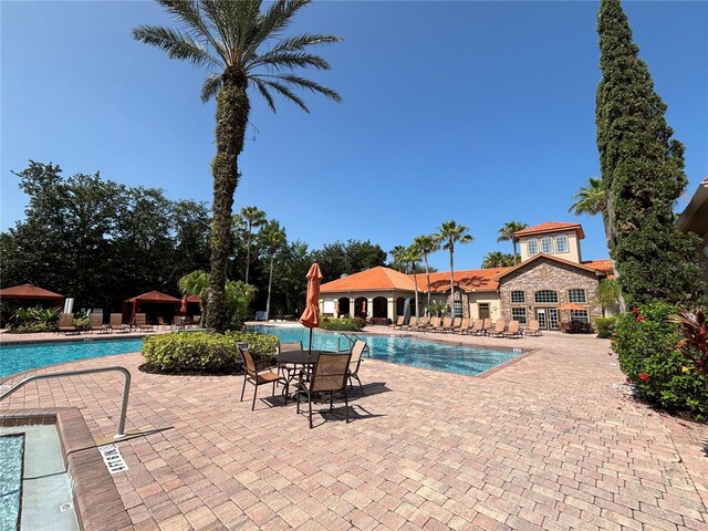 1375 Tuscana Ln Unit 1405, Davenport, FL 33896 - community pool with a patio area