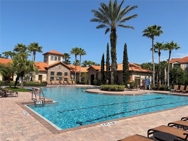 1375 Tuscana Ln Unit 1405, Davenport, FL 33896 - community pool featuring a patio area