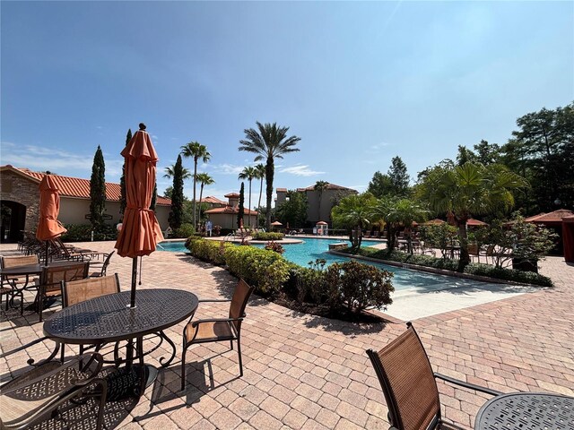 1375 Tuscana Ln Unit 1405, Davenport, FL 33896 - community pool with a patio area