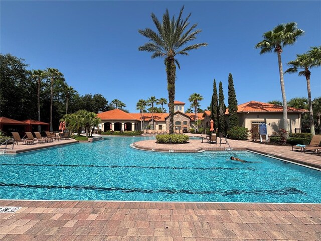 1375 Tuscana Ln Unit 1405, Davenport, FL 33896 - community pool featuring a patio area