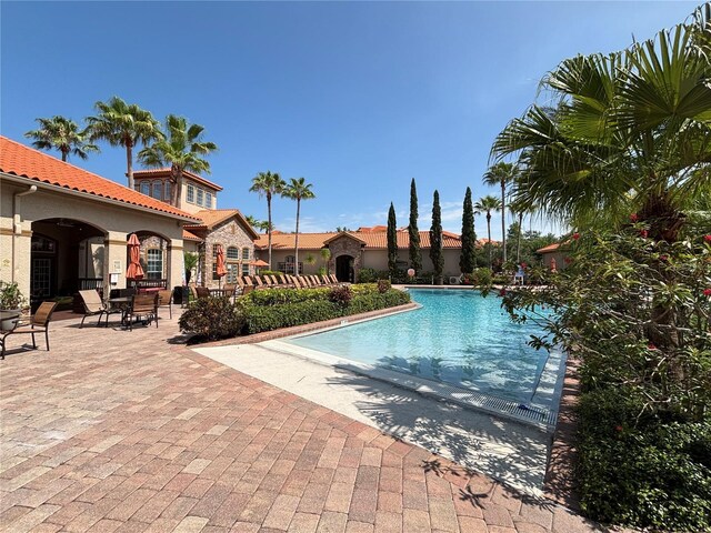 1375 Tuscana Ln Unit 1405, Davenport, FL 33896 - community pool featuring a patio