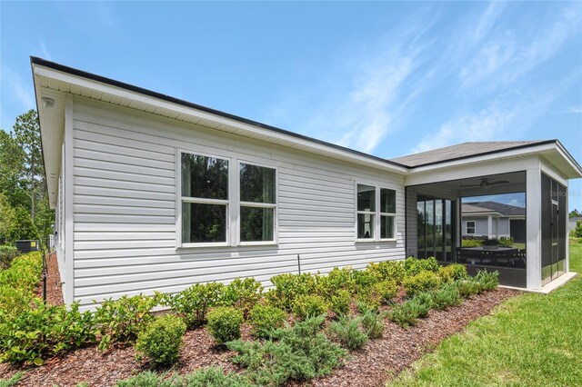 9211 Players Dr, Weeki Wachee, FL 34613 - view of side of home with a sunroom