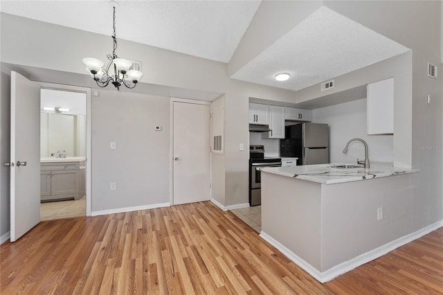 437 Fountainhead Cir Unit 283, Kissimmee, FL 34741 - kitchen with stainless steel appliances, under cabinet range hood, light wood-type flooring, and a textured ceiling