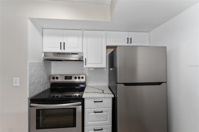 437 Fountainhead Cir Unit 283, Kissimmee, FL 34741 - kitchen featuring stainless steel appliances, under cabinet range hood, tasteful backsplash, white cabinetry, and light stone counters