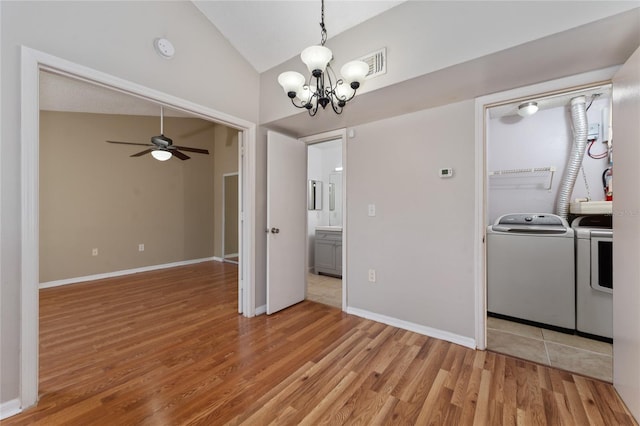 437 Fountainhead Cir Unit 283, Kissimmee, FL 34741 - kitchen featuring washing machine and dryer, light wood-style floors, a chandelier, ceiling fan, and high vaulted ceiling