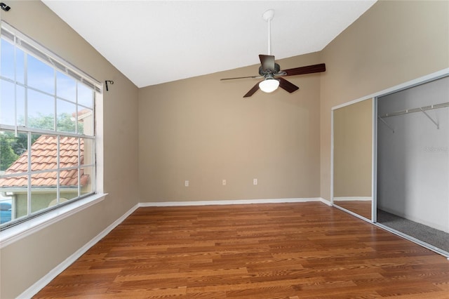 437 Fountainhead Cir Unit 283, Kissimmee, FL 34741 - unfurnished bedroom featuring lofted ceiling, wood finished floors, a closet, baseboards, and a ceiling fan