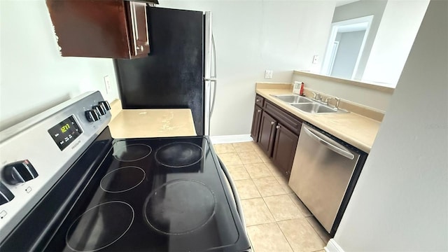 4728 Walden Cir Unit 32, Orlando, FL 32811 - kitchen with stainless steel appliances, light countertops, light tile patterned flooring, and dark brown cabinets
