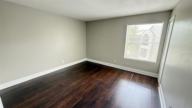 4728 Walden Cir Unit 32, Orlando, FL 32811 - spare room with dark wood finished floors and baseboards