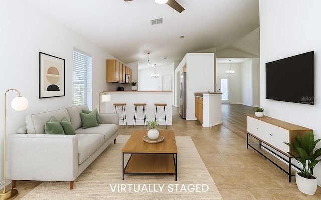 1851 Hammock Moss Dr, Orlando, FL 32820 - living area featuring a chandelier, light tile patterned floors, ceiling fan, and vaulted ceiling