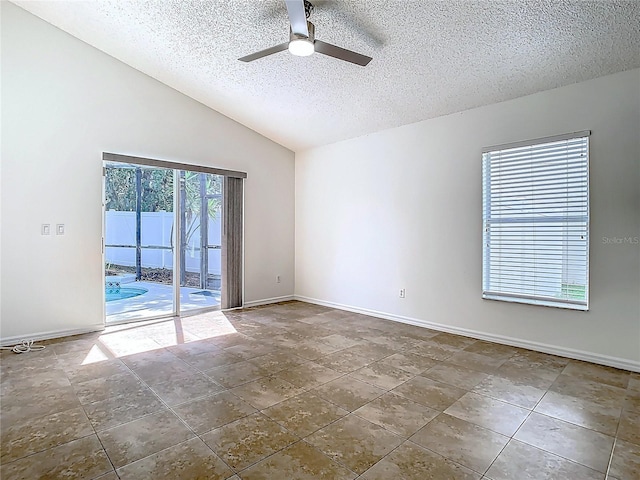 1851 Hammock Moss Dr, Orlando, FL 32820 - spare room with a textured ceiling, ceiling fan, vaulted ceiling, and baseboards