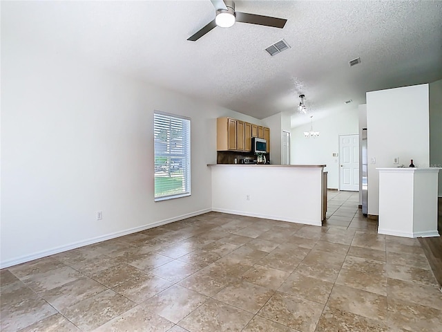 1851 Hammock Moss Dr, Orlando, FL 32820 - unfurnished living room with a ceiling fan, vaulted ceiling, a textured ceiling, a chandelier, and baseboards