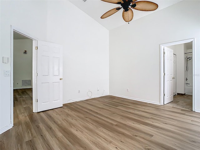 1851 Hammock Moss Dr, Orlando, FL 32820 - unfurnished bedroom featuring high vaulted ceiling, light wood-style floors, baseboards, ensuite bathroom, and ceiling fan