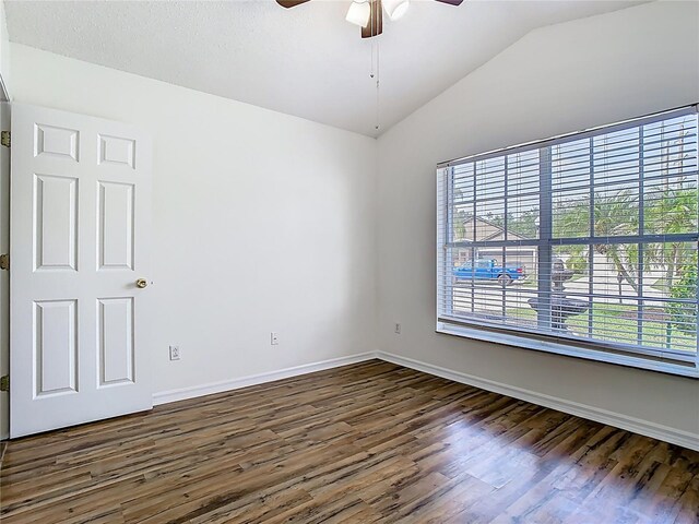 1851 Hammock Moss Dr, Orlando, FL 32820 - unfurnished room featuring lofted ceiling, dark wood finished floors, a ceiling fan, and baseboards