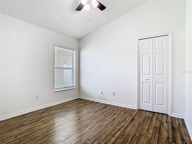 1851 Hammock Moss Dr, Orlando, FL 32820 - unfurnished room with dark wood-style floors, a ceiling fan, vaulted ceiling, baseboards, and a textured ceiling