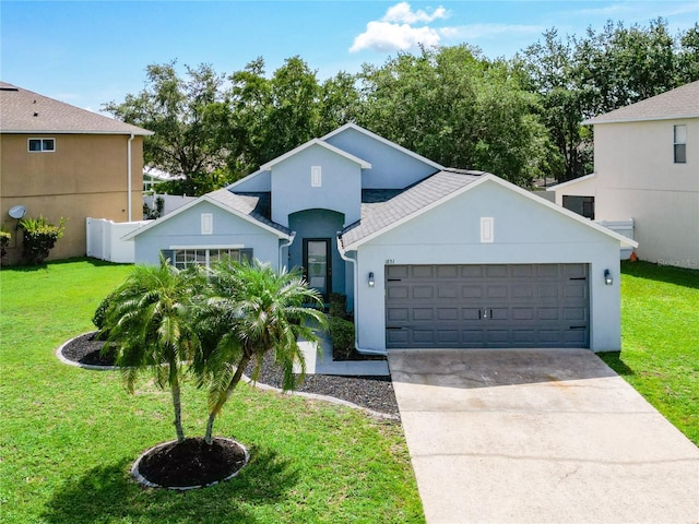 1851 Hammock Moss Dr, Orlando, FL 32820 - view of front of property with concrete driveway, an attached garage, a front lawn, and stucco siding