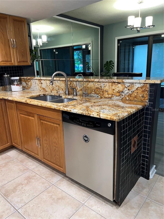 5826 Peregrine Ave Unit F01, Orlando, FL 32819 - kitchen featuring stainless steel dishwasher, a sink, a chandelier, and light stone countertops