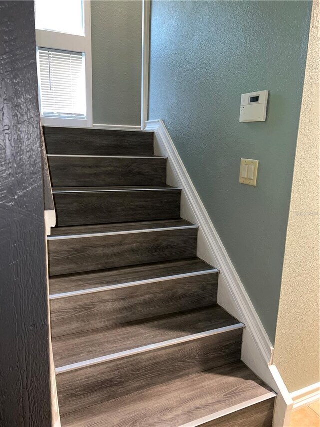 5826 Peregrine Ave Unit F01, Orlando, FL 32819 - stairs featuring a textured wall and baseboards