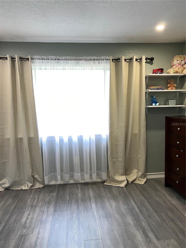 5826 Peregrine Ave Unit F01, Orlando, FL 32819 - unfurnished bedroom with dark wood-style flooring and a textured ceiling