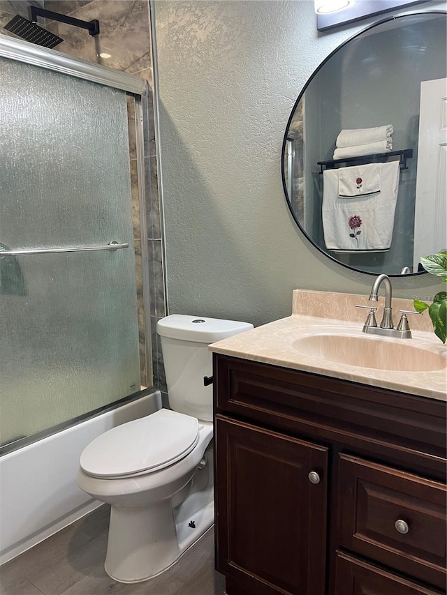 5826 Peregrine Ave Unit F01, Orlando, FL 32819 - bathroom featuring vanity, toilet, enclosed tub / shower combo, and a textured wall
