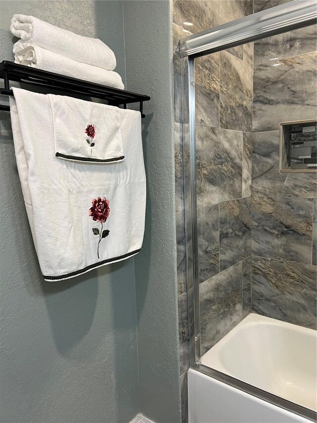 5826 Peregrine Ave Unit F01, Orlando, FL 32819 - full bathroom with a textured wall and enclosed tub / shower combo