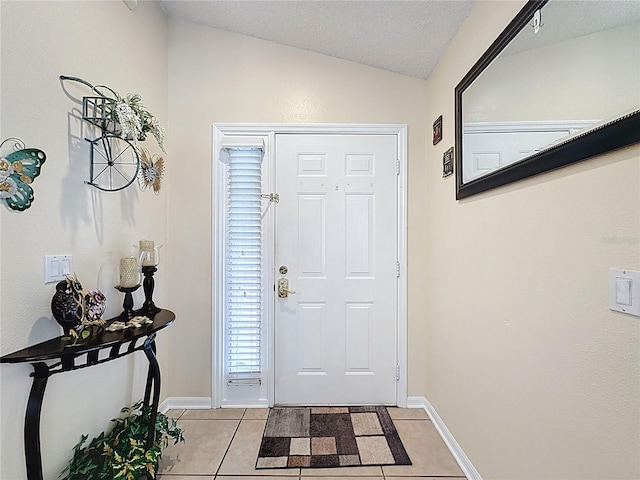 1364 Rebecca Dr, Haines City, FL 33844 - foyer featuring light tile patterned floors, lofted ceiling, baseboards, and a textured ceiling