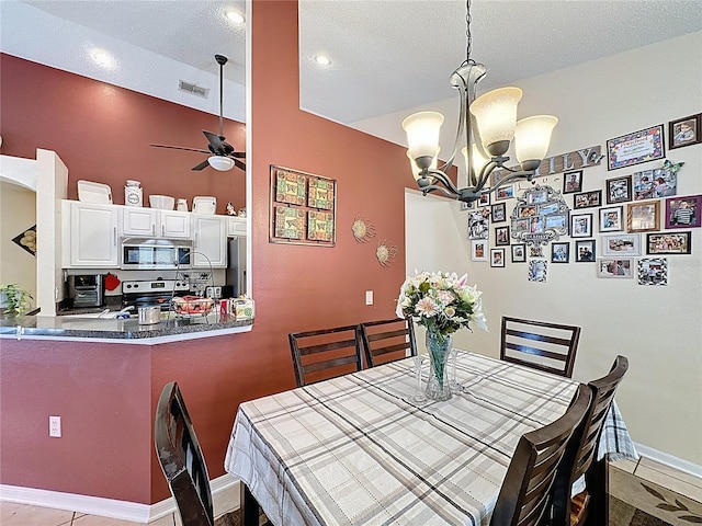1364 Rebecca Dr, Haines City, FL 33844 - dining room with ceiling fan, a chandelier, baseboards, a textured ceiling, and tile patterned floors