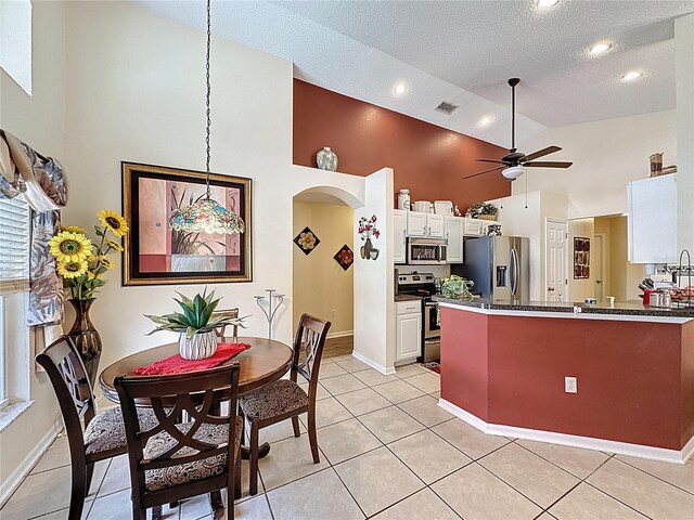 1364 Rebecca Dr, Haines City, FL 33844 - kitchen featuring stainless steel appliances, high vaulted ceiling, ceiling fan, a peninsula, and a textured ceiling